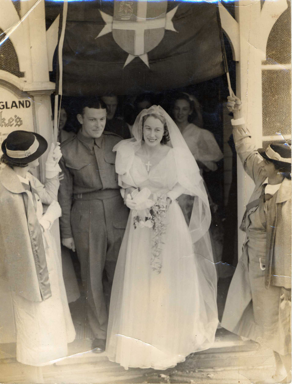 Ynys Fraser. Married at old St Luke&rsquo;s Church, Rotorua where members of St John created an archway of long splints. Guide Rangi is in the foreground.