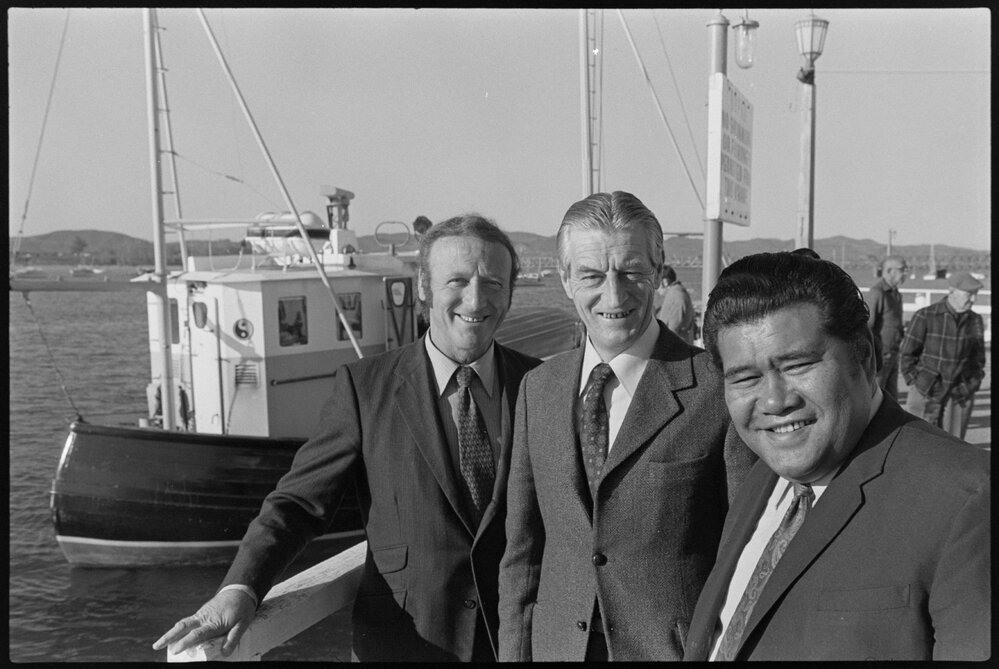 Three Labour MPs standing on wharf in front of protest yacht Boy Roel