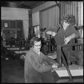 Henderson and Smyth engineers building low-profile orchard mowers.