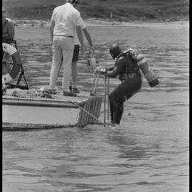 Diver emerges at the stern of "Reo"