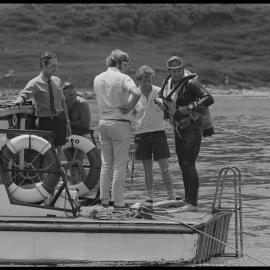 Diver emerges at the stern of "Reo"