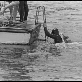 Diver emerges at the stern of "Reo"