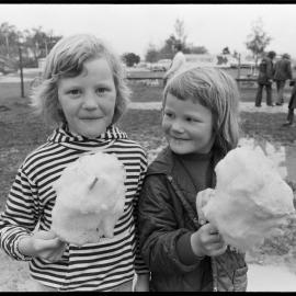 Two girls eating candy floss 