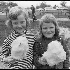 Two girls eating candy floss 