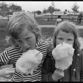 Two girls eating candy floss 