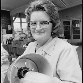 Mrs T. Paton with a light in factory