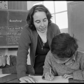 Kaimai School teacher supervises handwriting lesson