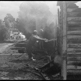 Man throws water over burning Welcome Bay home