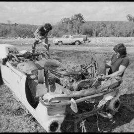 Men dismantle scrapped car