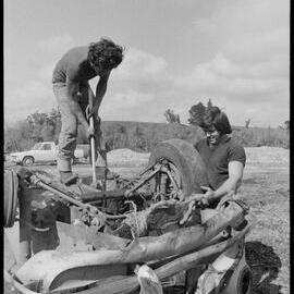 Men dismantle scrapped car