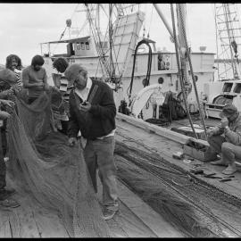 Repairing trawler fishing net