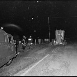 Firemen and a grader helping clear a spill of tallow on the Tauranga-Hamilton highway ndear Barkes Corner.