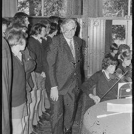 Prime Minister Norman Kirk entering an assembly during a visit to Tauranga Boys' College.