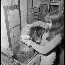 Preparing a meal over the wood stove at the Farm at Tamata a Taihuka.