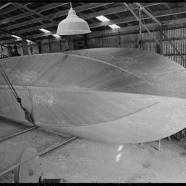 Turning a hull to an upright position using block-and-tackle.