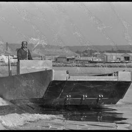 Mr A. Hyde testing a new jet barge on Tauranga Harbour.