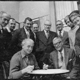 Mount Maunganui Returned Services Association preparing donation cheques for local clubs and organisations.