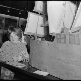 Inspecting a work at the primary schools' art exhibition.