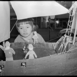Inspecting a work at the primary schools' art exhibition.