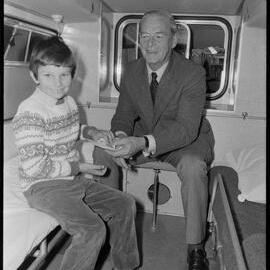 David Abernethy handing his family's donation to Tauranga St John Ambulance Association president Mr E. L. Faulkner.