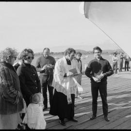 Father W. R. Fletcher blessing a newly-built fishing boat.