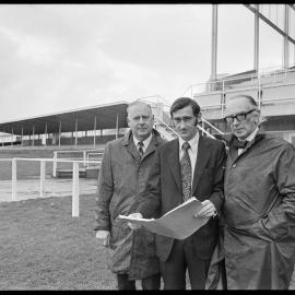 Horse racing. Bay of Plenty Racing Club officers look at sketch plans for a new public grandstand.
