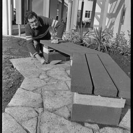 Installing rustic seats outside the Tauranga City Council building.