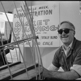 Blind basket weaver Mr Jim Williams demonstrates his skills in the window of Goddards Bookshop.