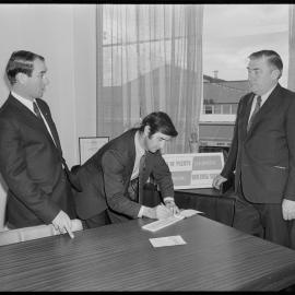 Bay of Plenty Co-operative Terminating Building Society secretary signing the cheque for its first contribution to local body development.