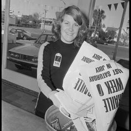Braille Week collection day. Janine Polley tips her collection into a bin.