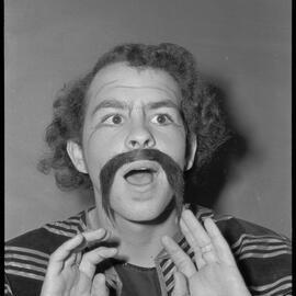 Unidentified performer preparing to go on stage in the Tauranga Girls' and Tauranga Boys' Colleges joint production of "Chu Chin Chow". Not published.