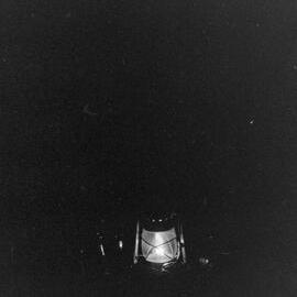 Unsuccessful photograph of a storm lantern in use at a Waihī hotel.