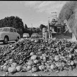 Removing two tons of spilled tamarillo and grapefruit skins from Waihī Rd near Judea.