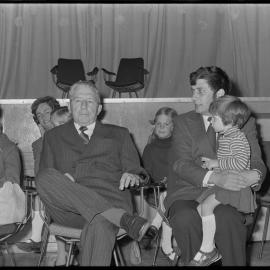 Retiring Waihī Doctor L. R. Hetherington and his wife at a retirement function alongside his replacement Dr D. J. Hardy (and child).