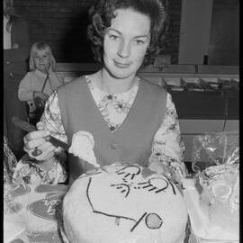 Mrs McNeilly judging an all-ages cake-baking contest.