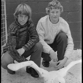 Murray and David Valentine with a large seabird they found exhausted on the beach.