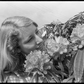 Mandy McLean viewing new rhododendron flowers in a Tauranga garden.
