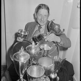 Mr F. J. Cole of Judea with some of his trophies won at regional A and P shows for growing vegetables.