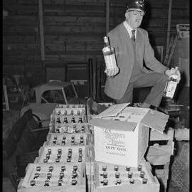 Mr D. Henton auctioning beer and spirits confiscated by police.