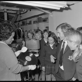 Ōtūmoetai College concert choir and orchestra members watching their latest record being pressed.