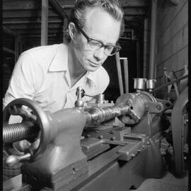 P. K. Watson works on lathe