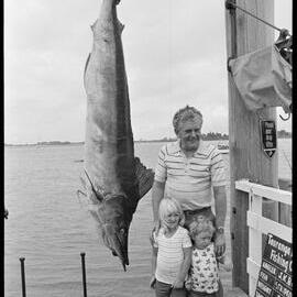 Large striped marlin catch, spectators