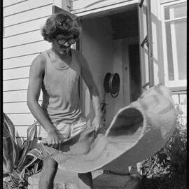 Swiss tourist shakes out a rug