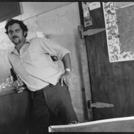 Man next to flagon and glasses