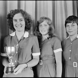 Girls in uniform with a trophy