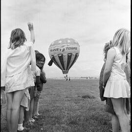 Children wave good-bye to Hot Air Balloon