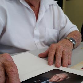 Bill Chapman showing a recent portrait taken for ANZAC Day