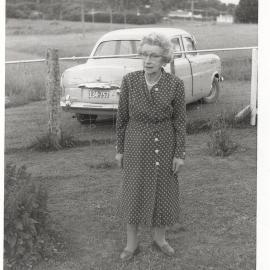 Behind Grandma, in this photograph taken in the late 1950s, Hill Farm slopes away to the road gate near the white house in the background