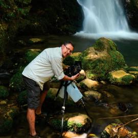 Ken Wright photographing a waterfall at Otanewainuku Forest (2012)