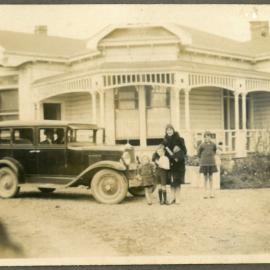 Family and car outside house